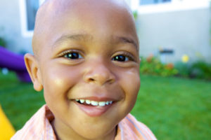 A Handsome little African American Boy smiling for the camera
